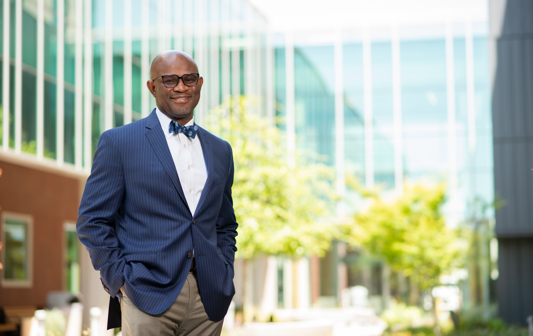man with eye glasses in suit with blue bow-tie and great smile corporate headshot on location photography JPVisual Los-Angeles